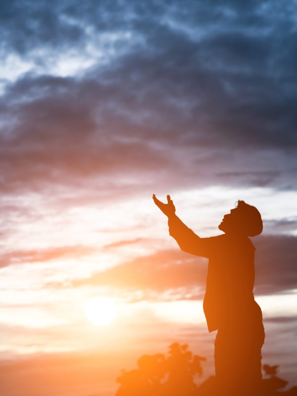 silhouette of handsome asian man praying.